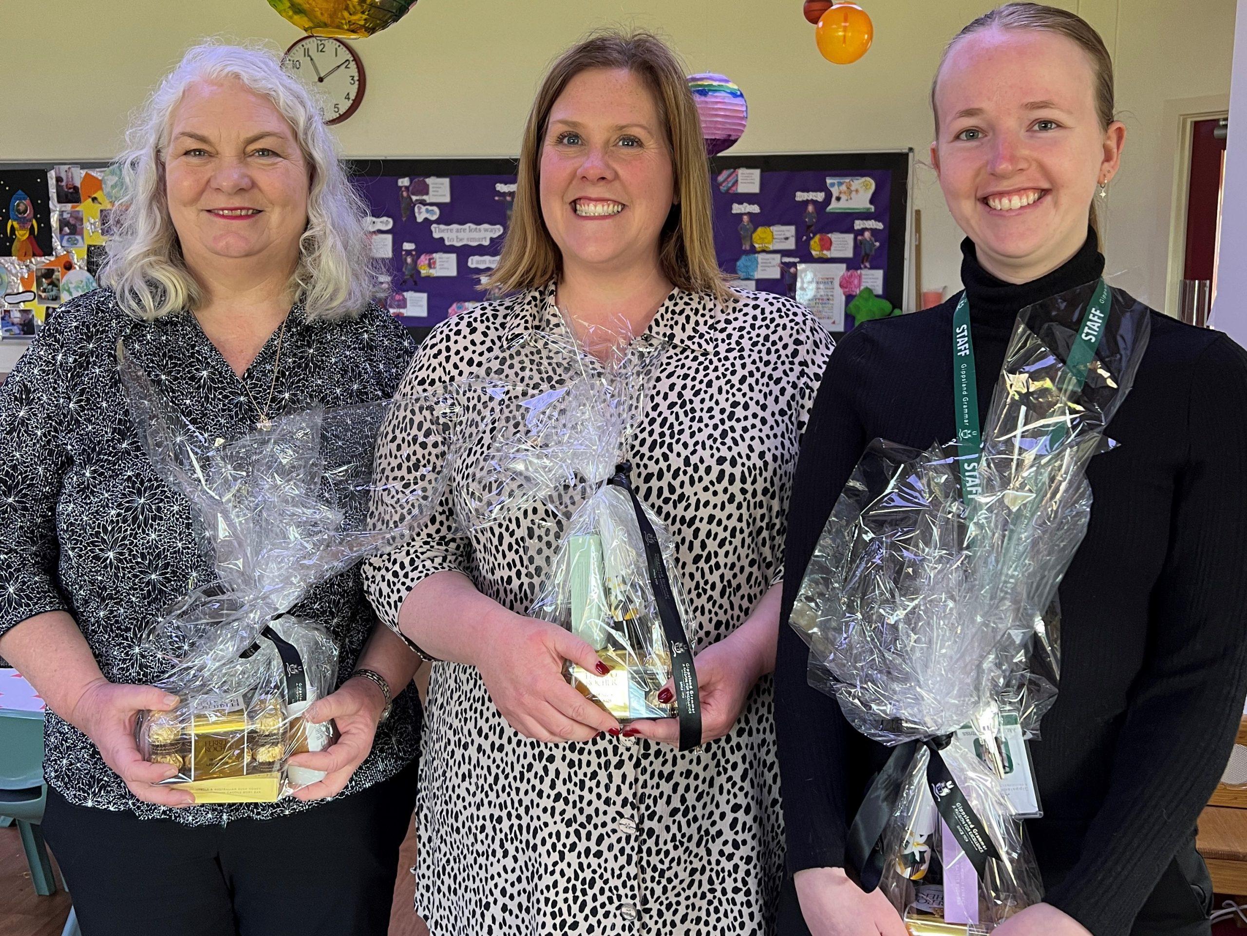 Bairnsdale ELC educators Sharon Smith, Sommer-Lea Collins and Maddy Cuttriss receive their special hampers on Early Childood Educators’ Day.